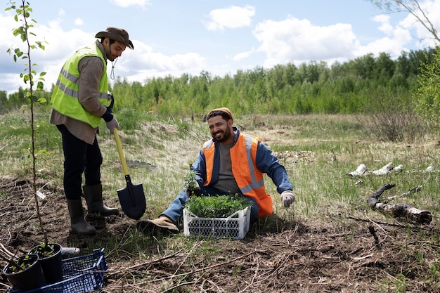 Workers planting tree saplings in a deforested area of the United States, focusing on their collaborative effort to restore the forest. The image captures the dedication and hard work involved in reforestation projects, showcasing the physical labor and teamwork required for success. Include a mix of volunteers and professionals, emphasizing the community involvement in environmental restoration.