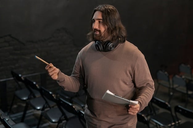 A man, formerly incarcerated, confidently speaking at a public hearing, with a microphone in front of him. He is addressing a panel of legislators, and the setting is a formal hearing room in a government building.