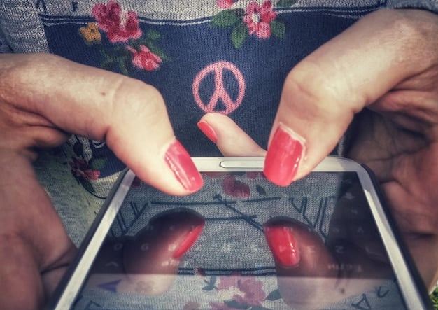 A close-up photo of a hand holding a smartphone displaying an artist's digital artwork about mental health. Comments and likes are visible, showcasing engagement from followers.