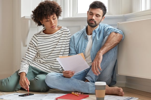 A medium shot of a community organizer sitting across from a young couple, reviewing their financial documents and offering personalized advice.