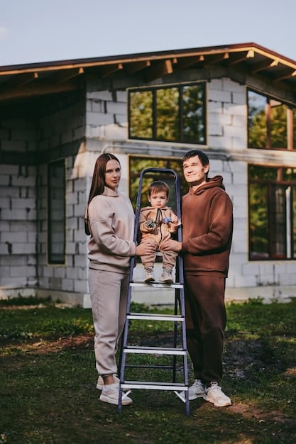 A wide shot of a newly constructed, affordable home, with a family standing in the front yard, beaming with pride and holding the keys to their new house.
