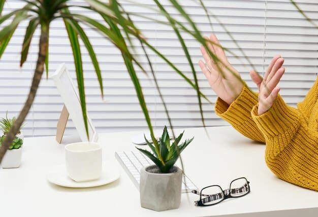 A person working at a tidy and minimalist desk with a plant and a calming background, representing a mindful workspace conducive to stress reduction and focused work.