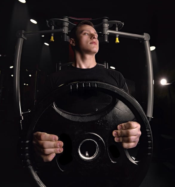 A person lifting weights in a gym, focusing on proper form and technique.