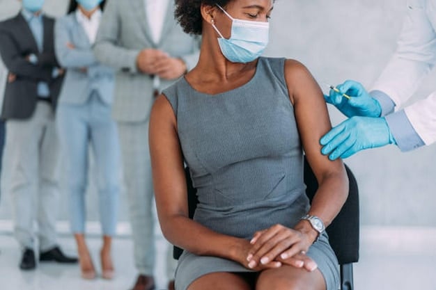 A close-up shot of a healthcare professional administering a flu shot to a patient's arm in a clinic setting. The image should convey trust and safety.