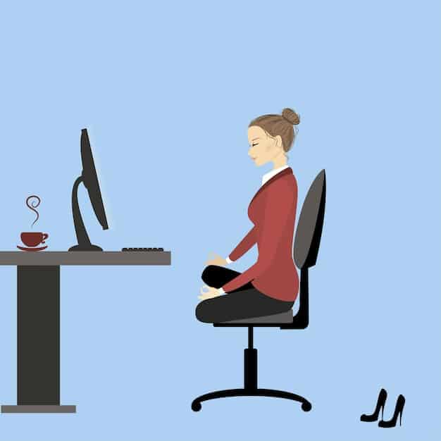 A person sitting at a desk with poor posture, hunched over a computer, rounded shoulders, forward head. Showing the ergonomic issues.