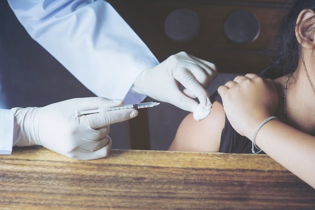 A doctor administering an allergy skin prick test on a patient's arm.