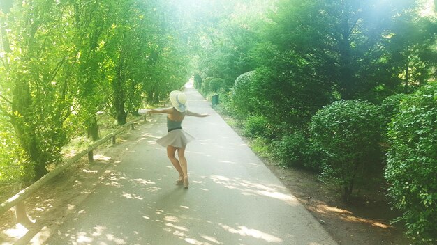 A person jogging outside in a scenic park, surrounded by green trees and a clear sky, representing the benefits of aerobic exercise. The individual is wearing fitness attire and appears energetic and motivated.