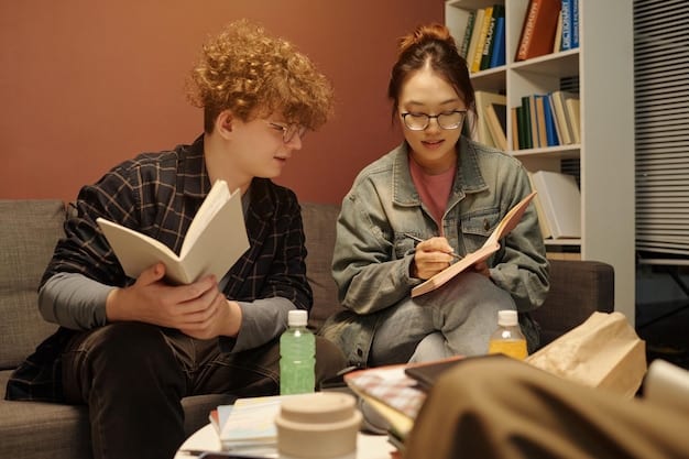 A mentor is sitting with a young person, reviewing a school assignment together. The setting is a quiet library and both are focused and engaged in the task.