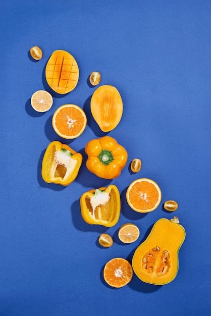 Collage of various foods high in Vitamin C, such as oranges, strawberries, bell peppers, and spinach. These are positioned around a bottle of Vitamin C supplements, emphasizing the combined approach of diet and supplements.