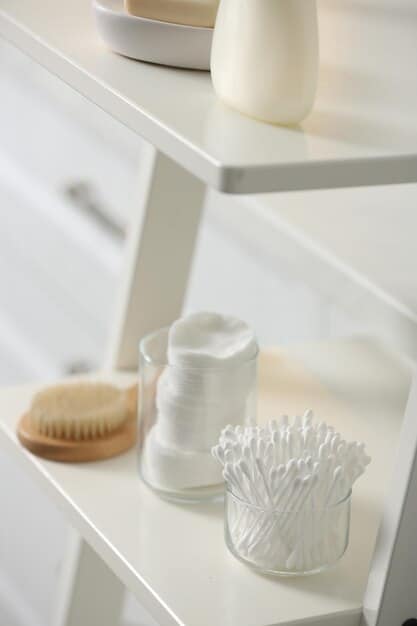 A well-organized shelf in a bathroom with various skincare products designed for sensitive skin, including cleansers, moisturizers, and serums. The color palette is soft and calming, and the products are in minimalist packaging.