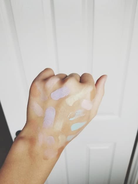 Close-up photo of fingers applying a thick, white mineral sunscreen on skin, highlighting the texture and opacity of the product.