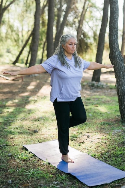 A woman in her late 50s practicing yoga gracefully outdoors, emphasizing flexibility and strength, with a focus on bone health and joint support.