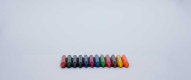 Several supplement capsules of different colors and shapes neatly arranged on a minimalist white background, with scientific beakers and subtle skincare elements in the soft focus background, highlighting analytical selection.