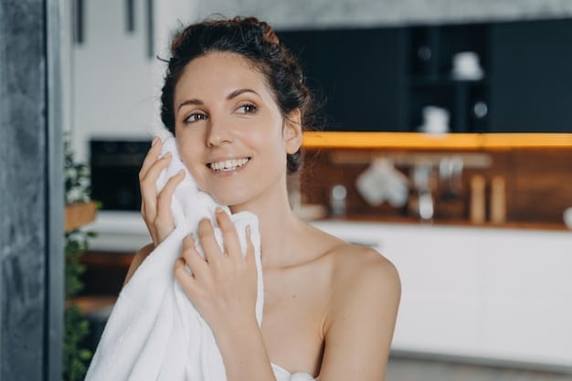 A person gently patting their face dry with a soft, clean towel after cleansing, emphasizing proper, gentle skincare techniques in a brightly lit bathroom.