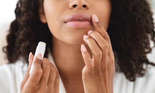A person's hand gently applying a repair balm to chapped lips, with a soft focus on the texture of the balm and the skin, conveying soothing relief.