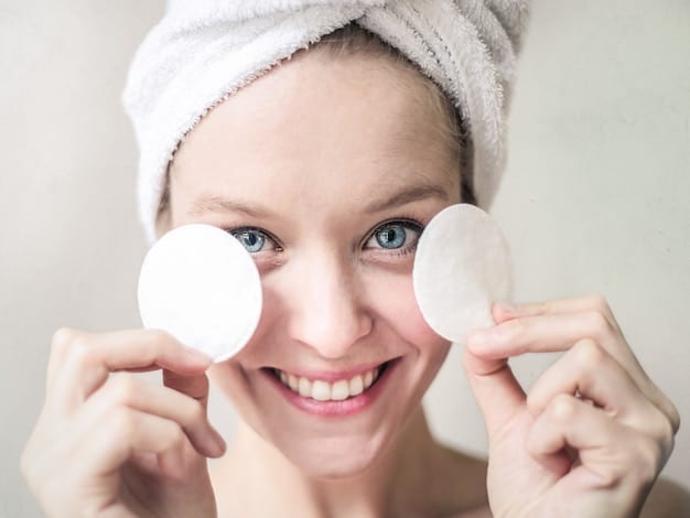 A close-up of a person gently patting toner onto their face with a cotton pad, showcasing clean, refreshing skin. The background is a clean bathroom, implying a daily routine.