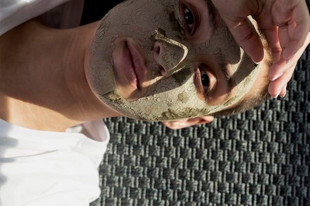 A person applying a clay mask to their face, with a focus on areas commonly affected by oily skin and breakouts, like the T-zone. The scene is calm, suggesting a self-care routine.